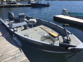 Boat With Paddle And Net By The Docks