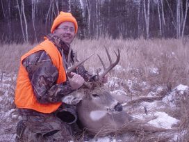 Guest Is Hunting Gear Holding Deer By Antlers