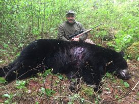 Guest With Rifle And Huge Black Bear